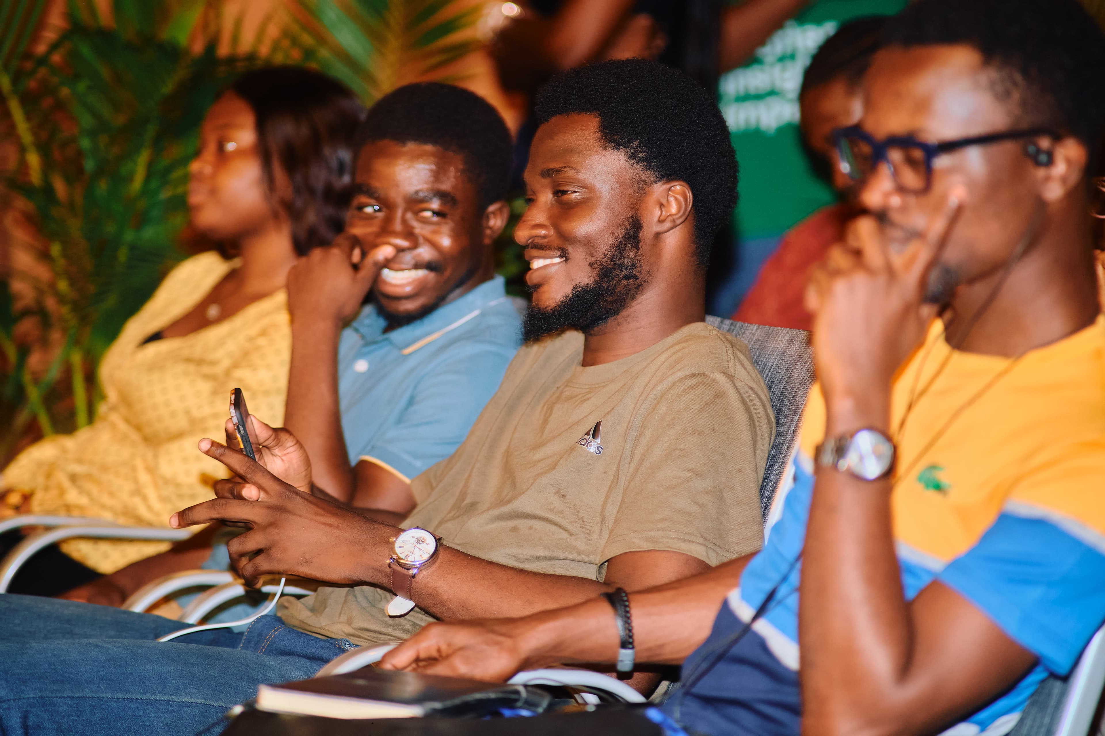 Attendees laughing together during a session at a tech community event.