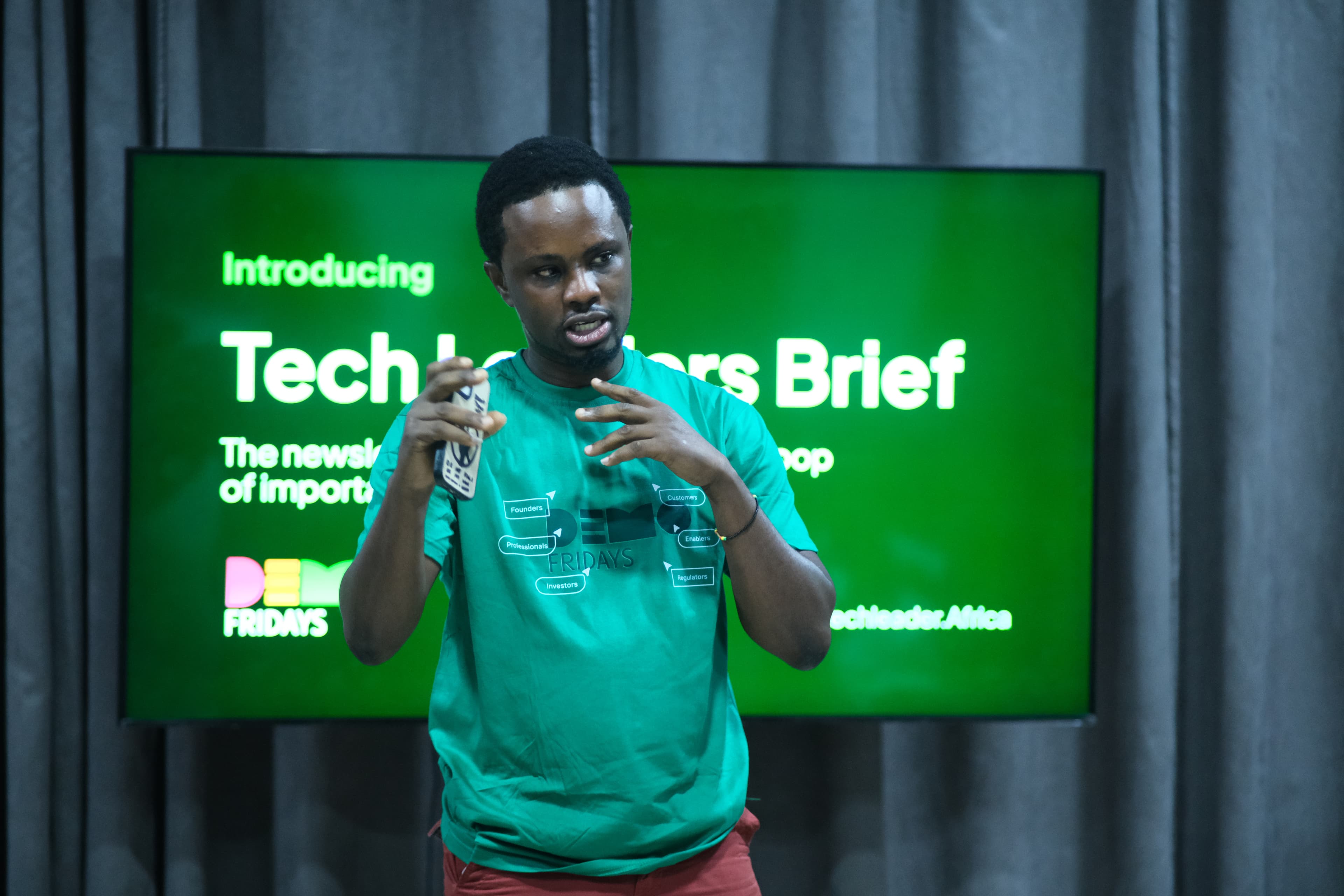 A speaker introducing the Tech Leaders Brief newsletter on stage.