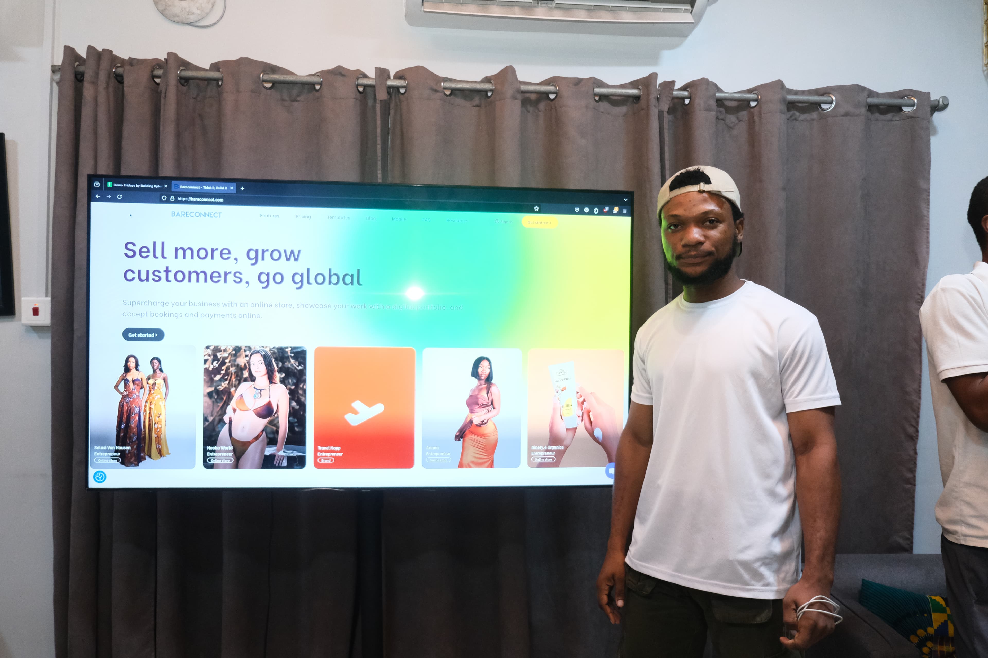 A presenter demonstrating a product on screen to the audience.